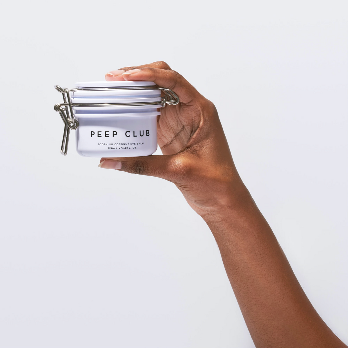 Soothing Coconut Eye Balm 40 ml pot in hand